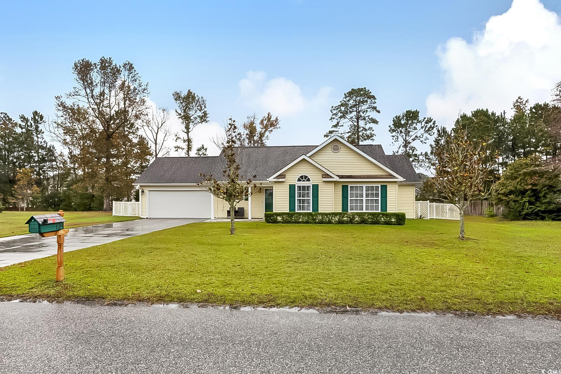 Ranch-style home with a front yard and a garage