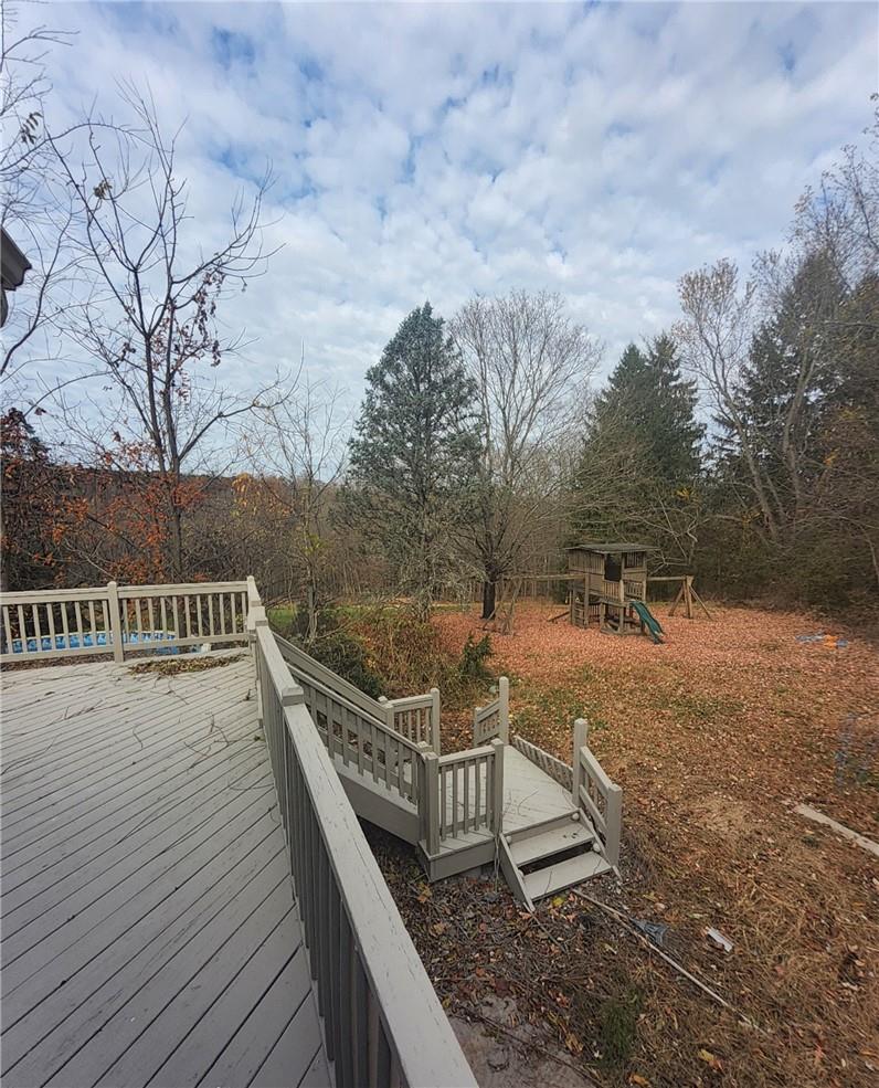 a view of a balcony with wooden floor and fence