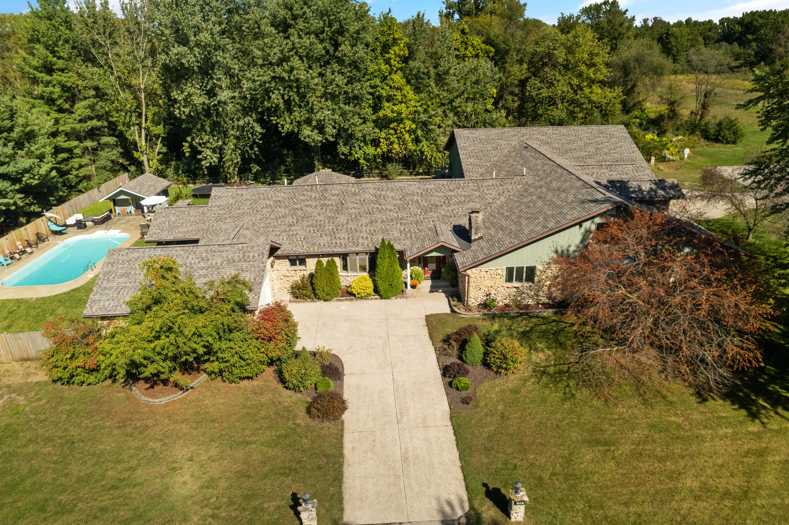 an aerial view of a house with a yard