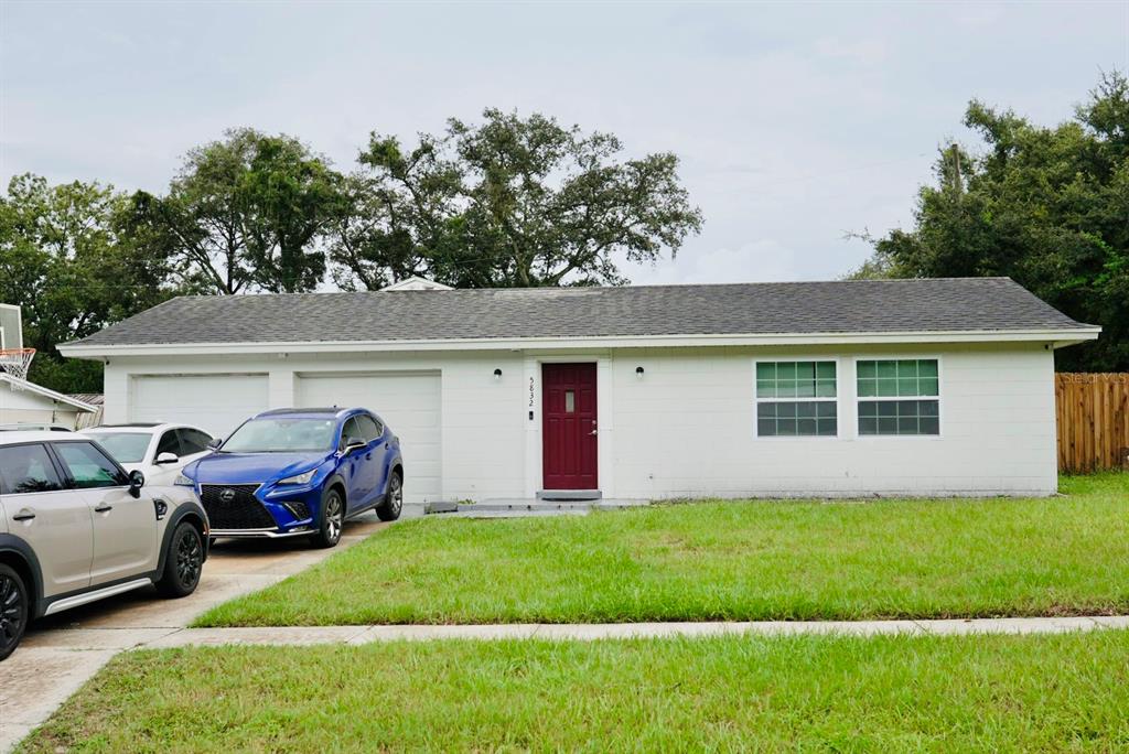 a front view of a house with a garden and yard