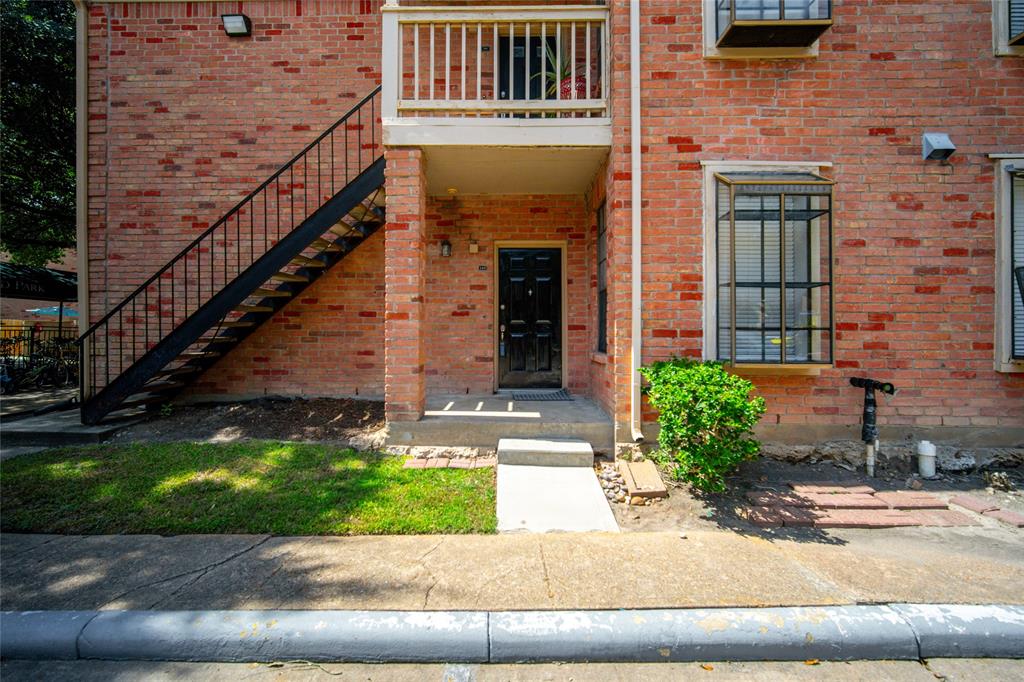 a front view of a house with garage and plants