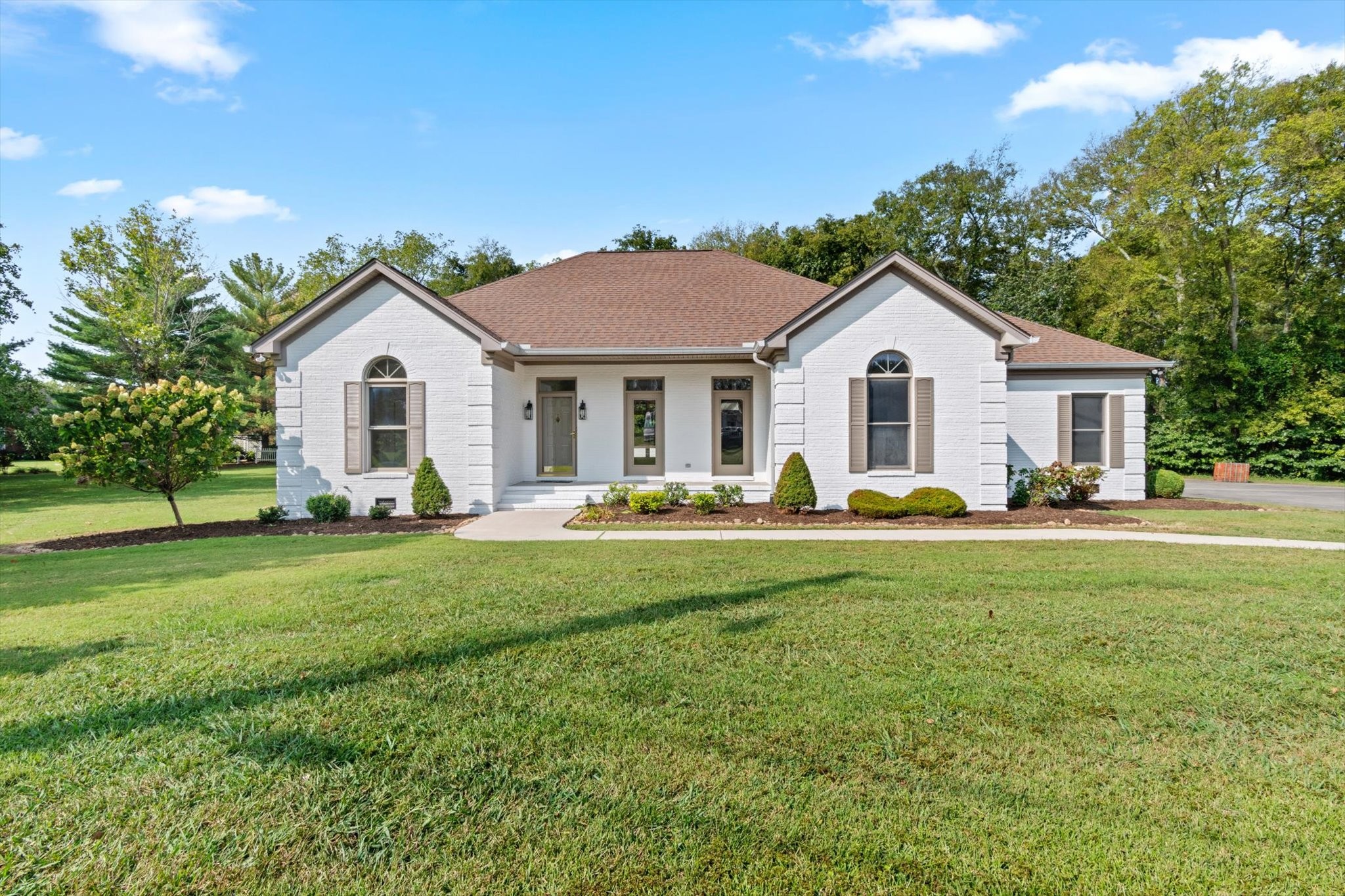 a front view of house with yard and green space