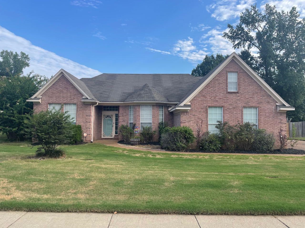 a front view of a house with a yard