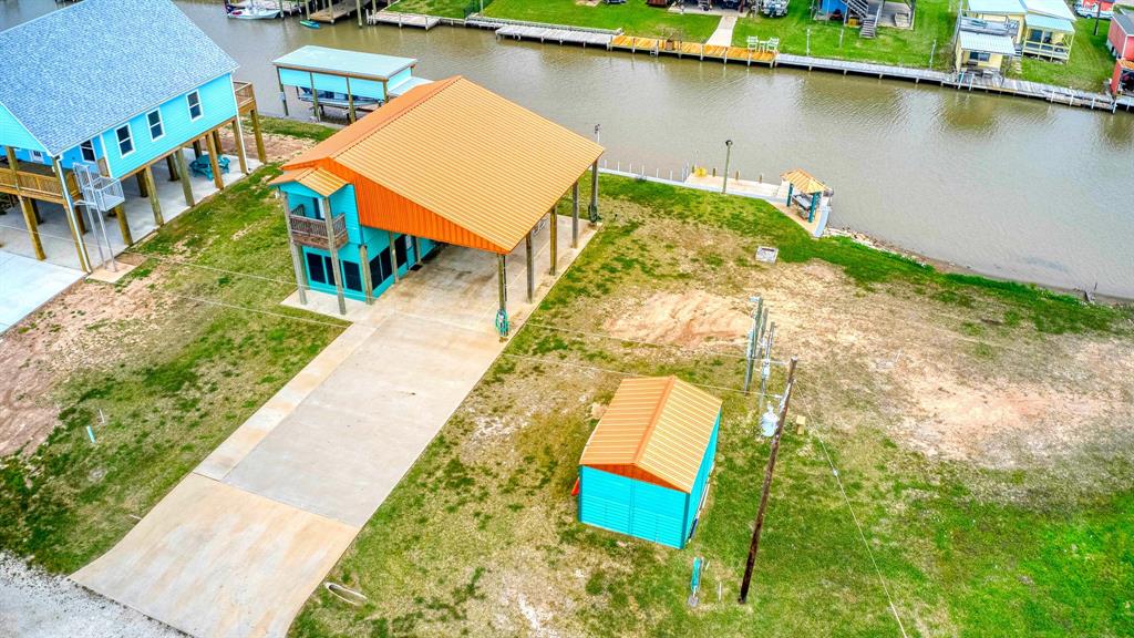 an aerial view of a house with a yard and lake view