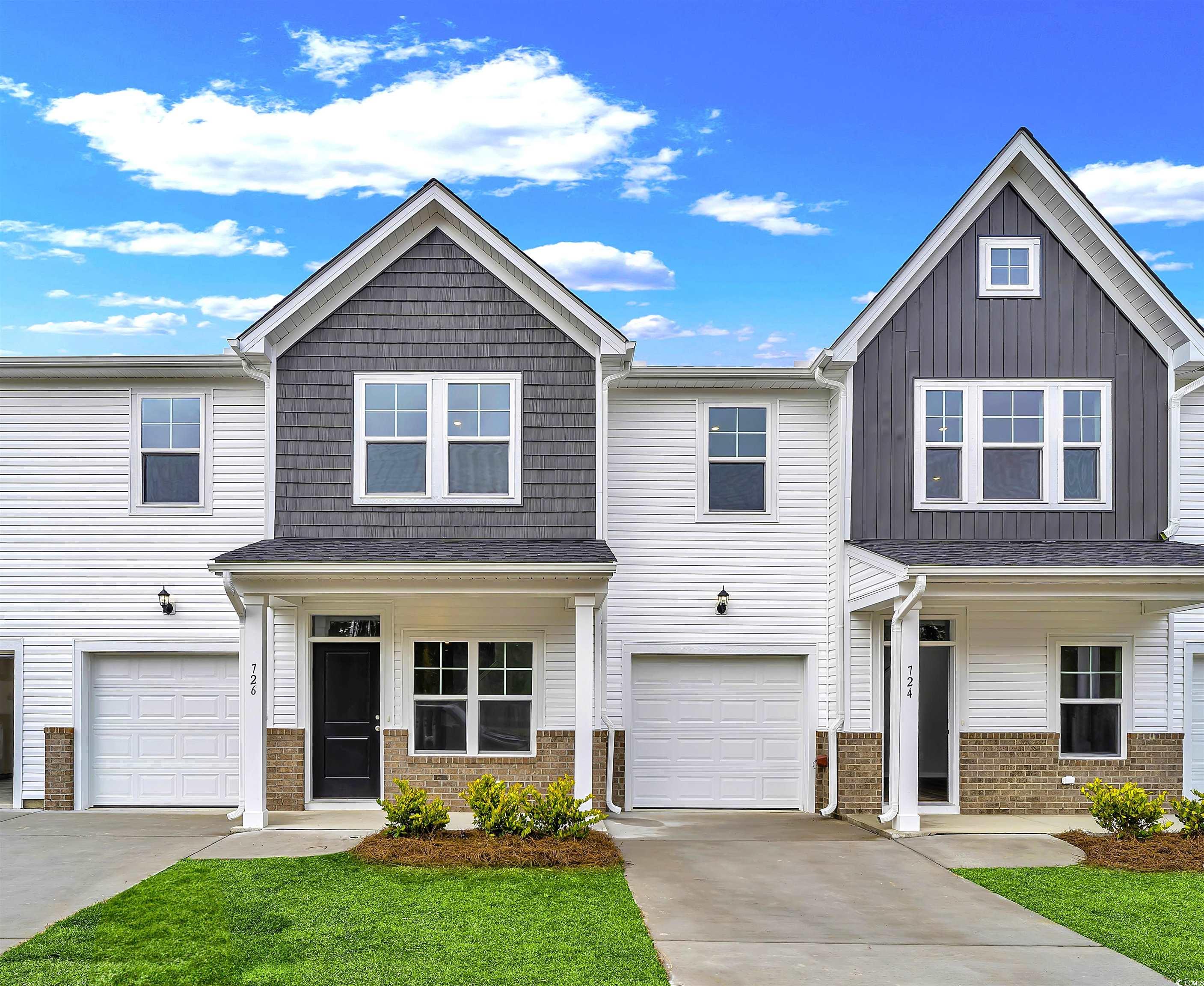 View of front of property featuring a garage and a