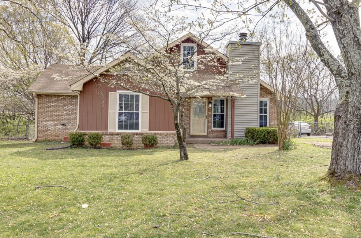 a house that has a tree in front of it