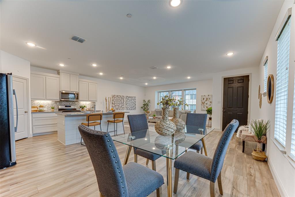 a view of a dining room with furniture kitchen and wooden floor