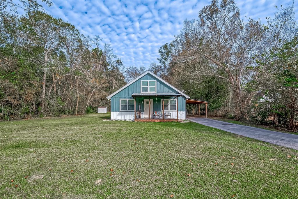 a front view of a house with yard and green space