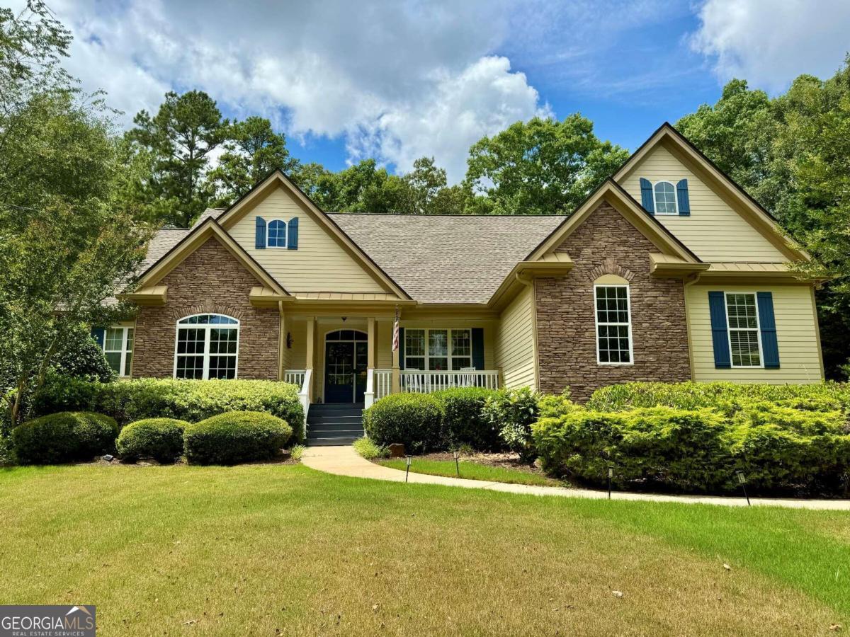 a front view of a house with a garden