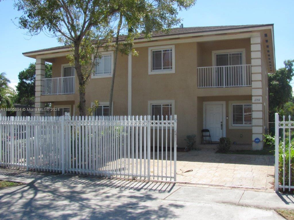 a front view of a house with a fence