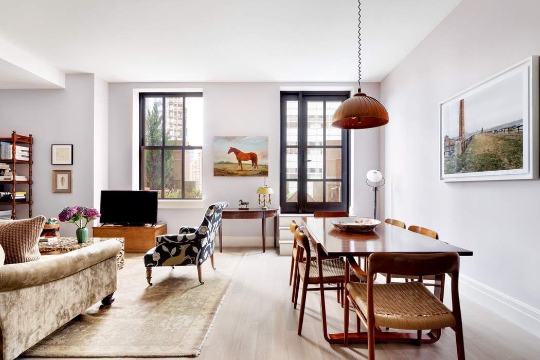 a living room with furniture a window and a flat screen tv