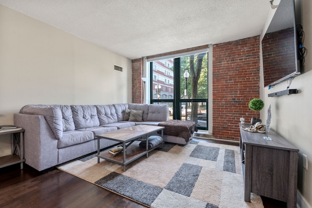 a living room with furniture wooden floor and a flat screen tv