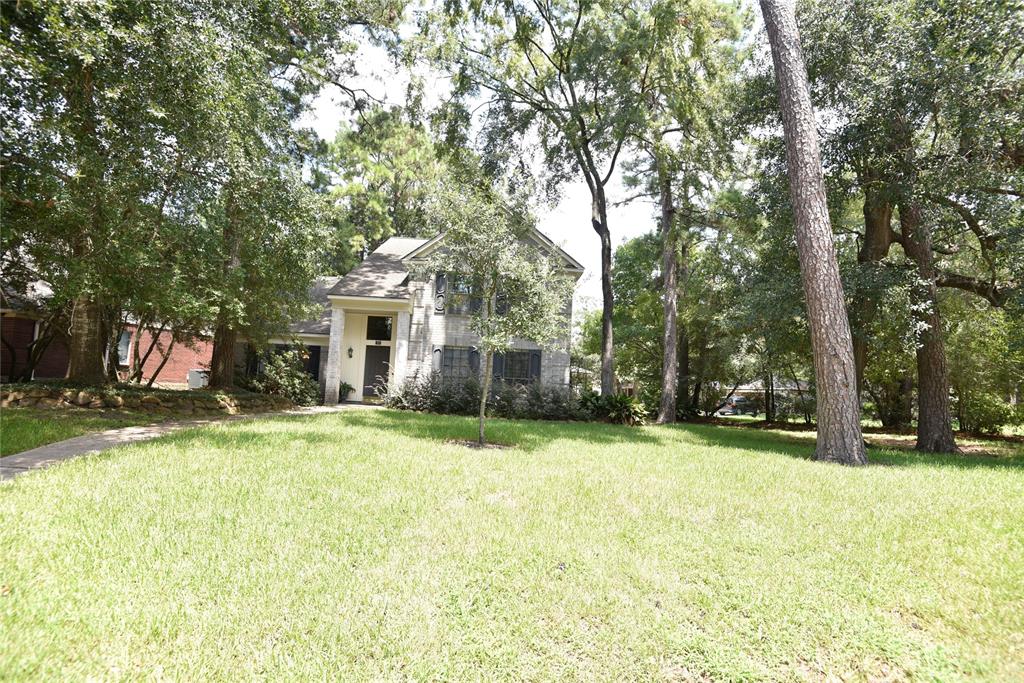 a brick house with trees in front of it