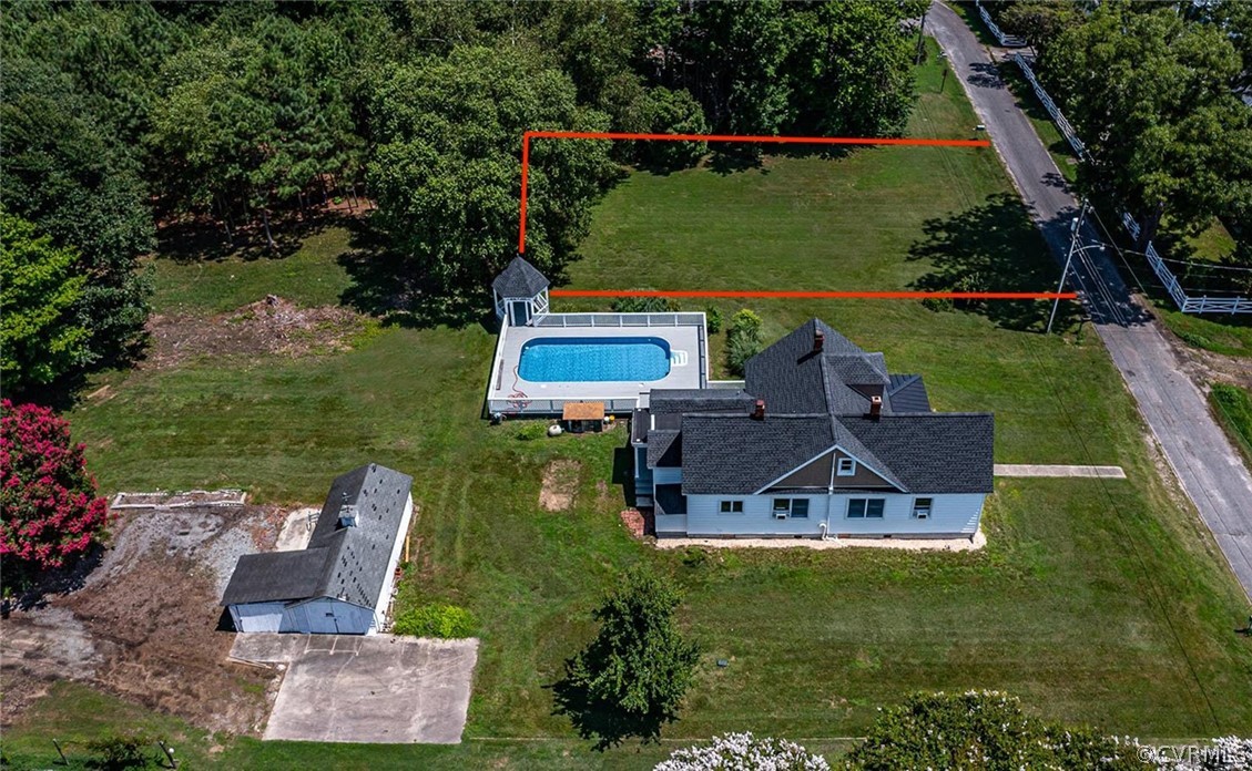 an aerial view of a house with a garden and trees