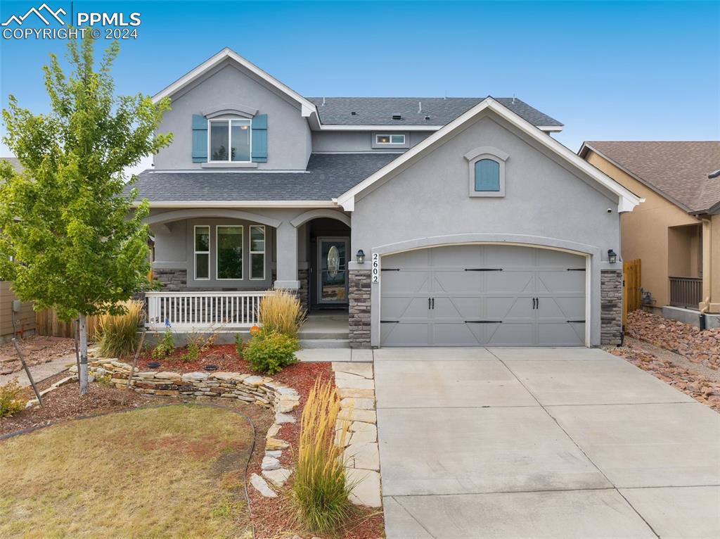 a front view of a house with garage