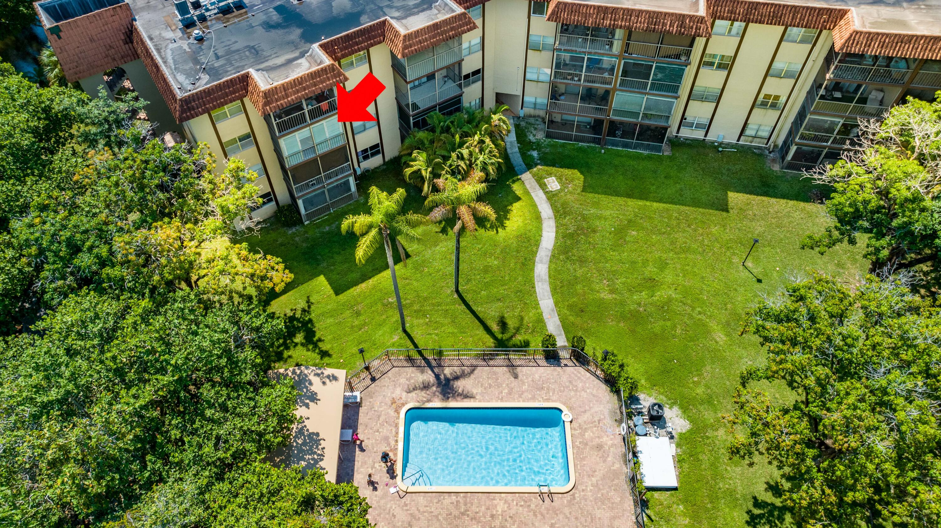 an aerial view of a houses with swimming pool