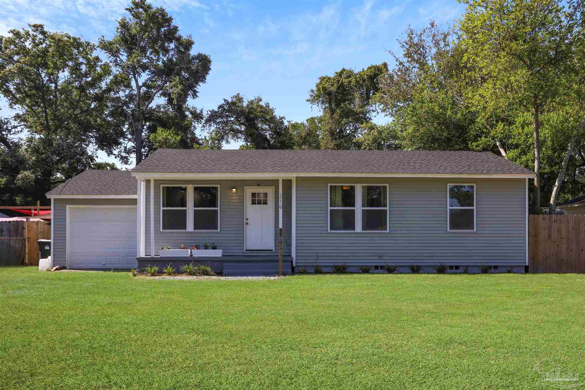 a front view of house with yard and green space