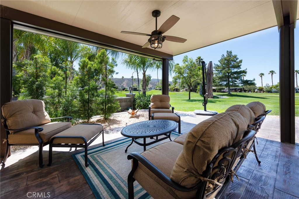 a view of a patio with furniture and a backyard