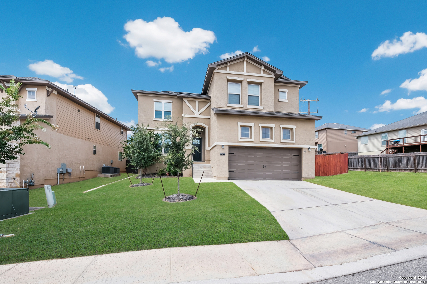 a front view of a house with a yard and garage