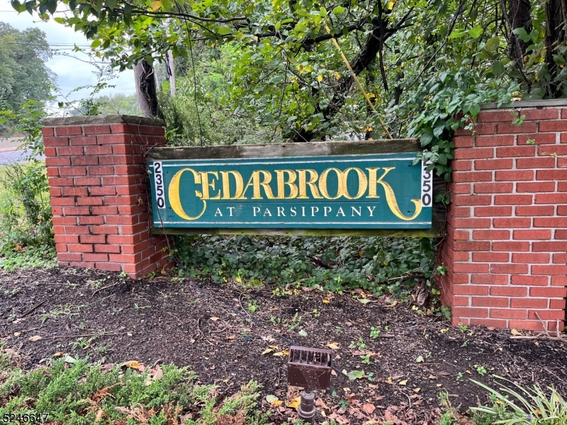 a sign broad in front of a red brick house