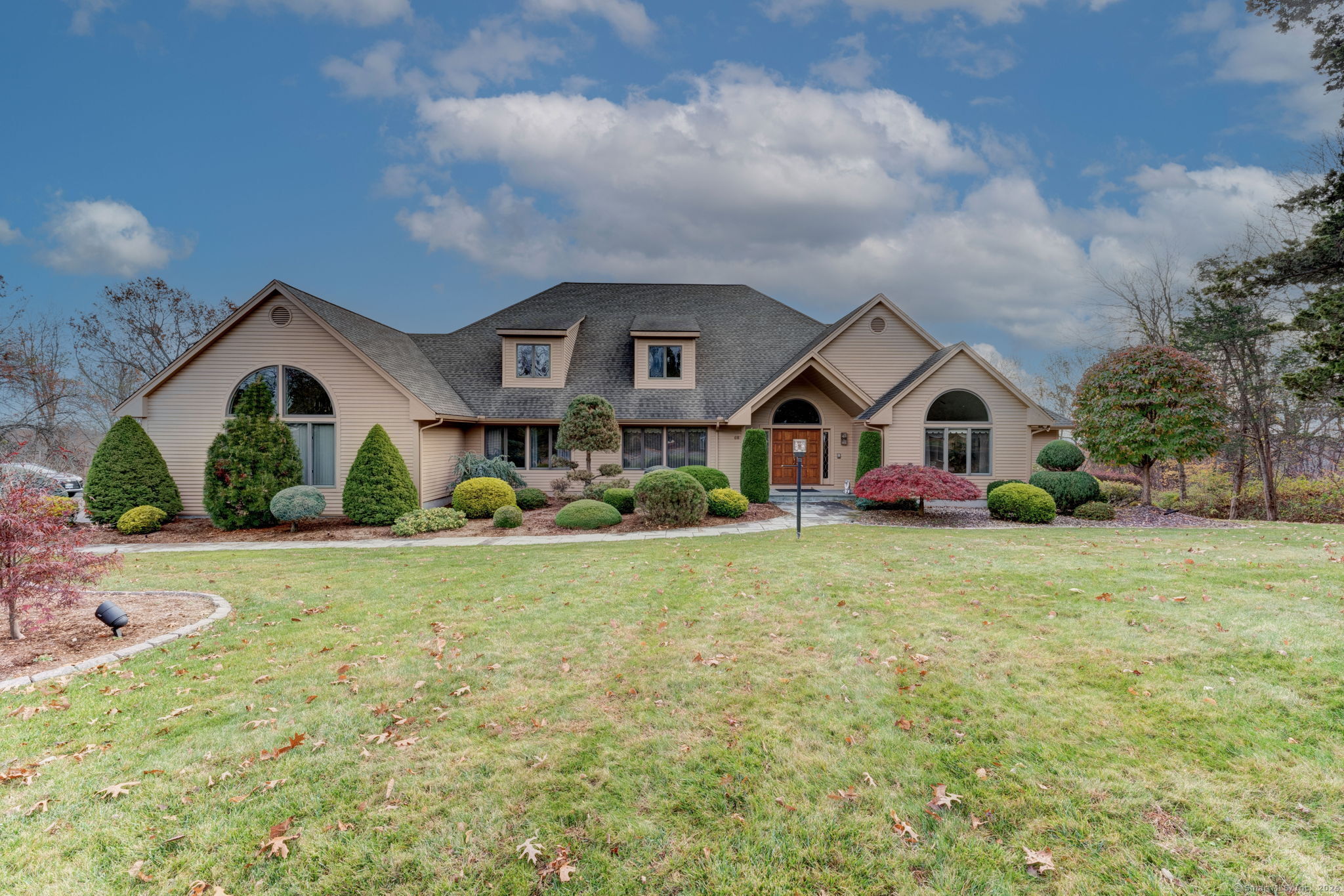 a front view of a house with garden