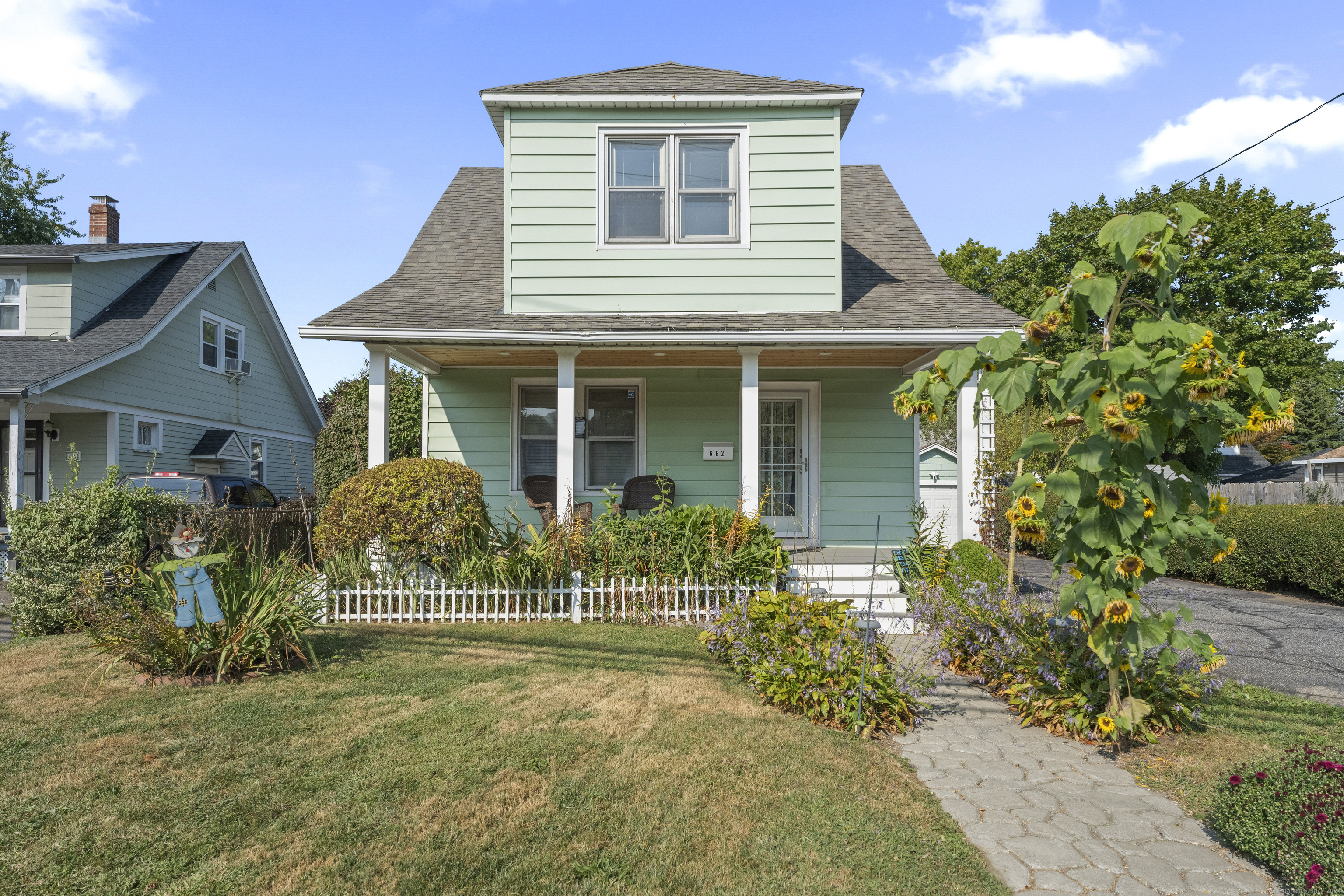 a front view of a house with garden