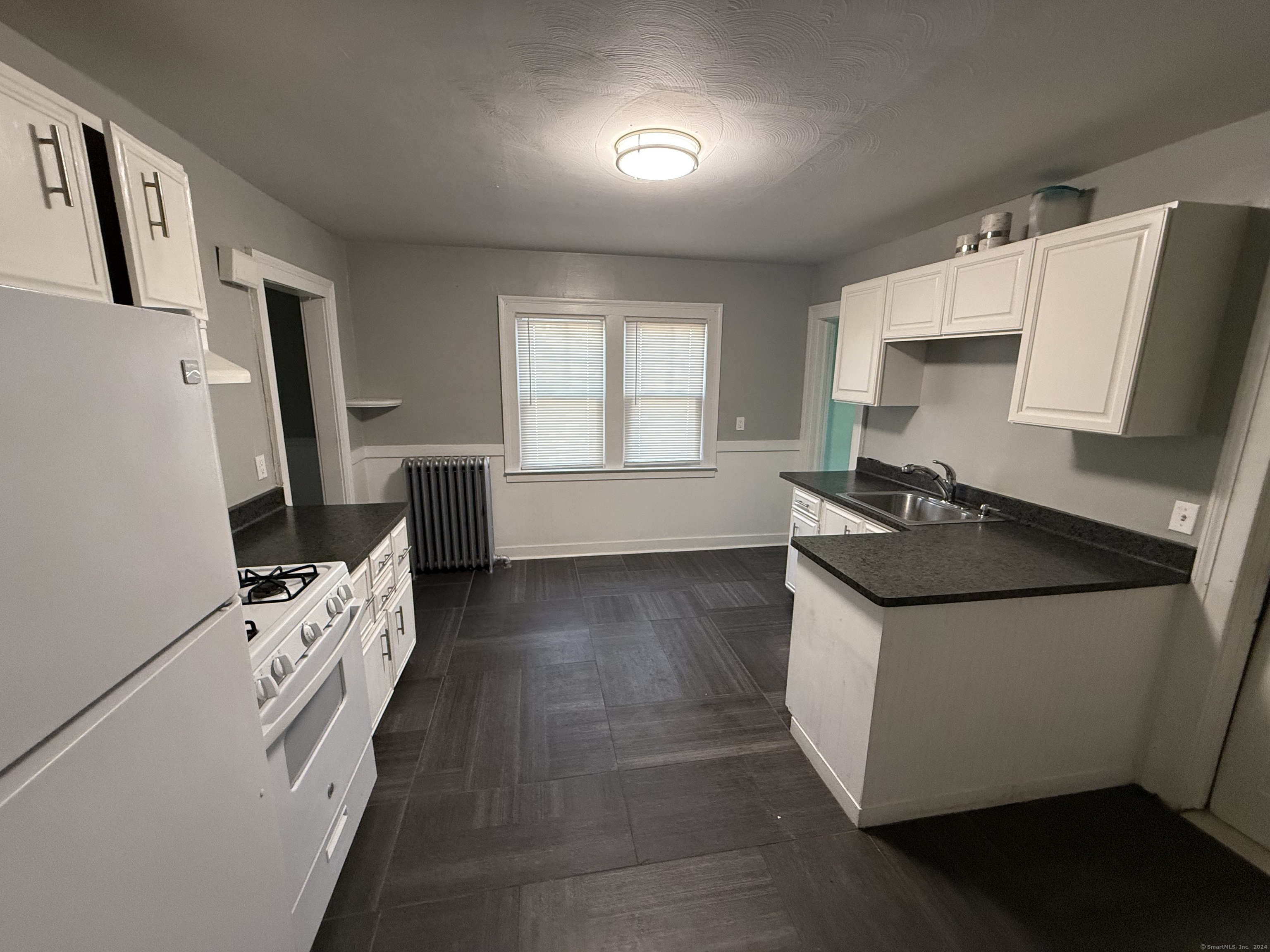 a kitchen with a sink a stove and a refrigerator