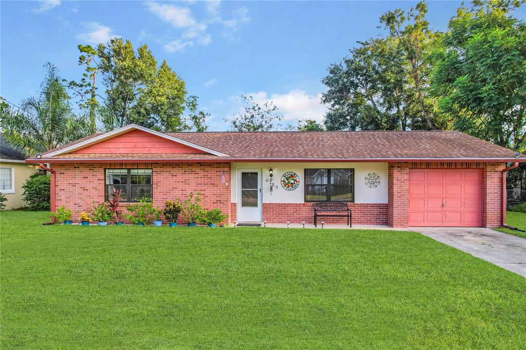 a front view of a house with a yard and porch