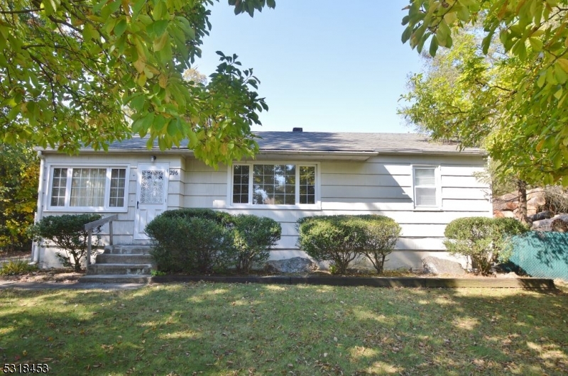 a front view of a house with yard and green space