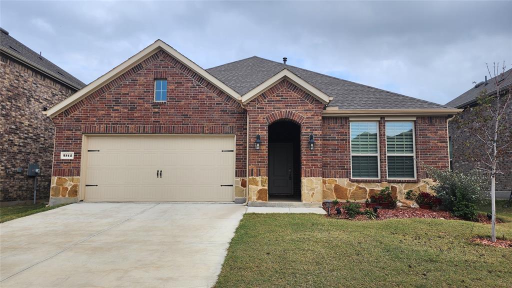 a front view of a house with a yard outdoor seating and garage