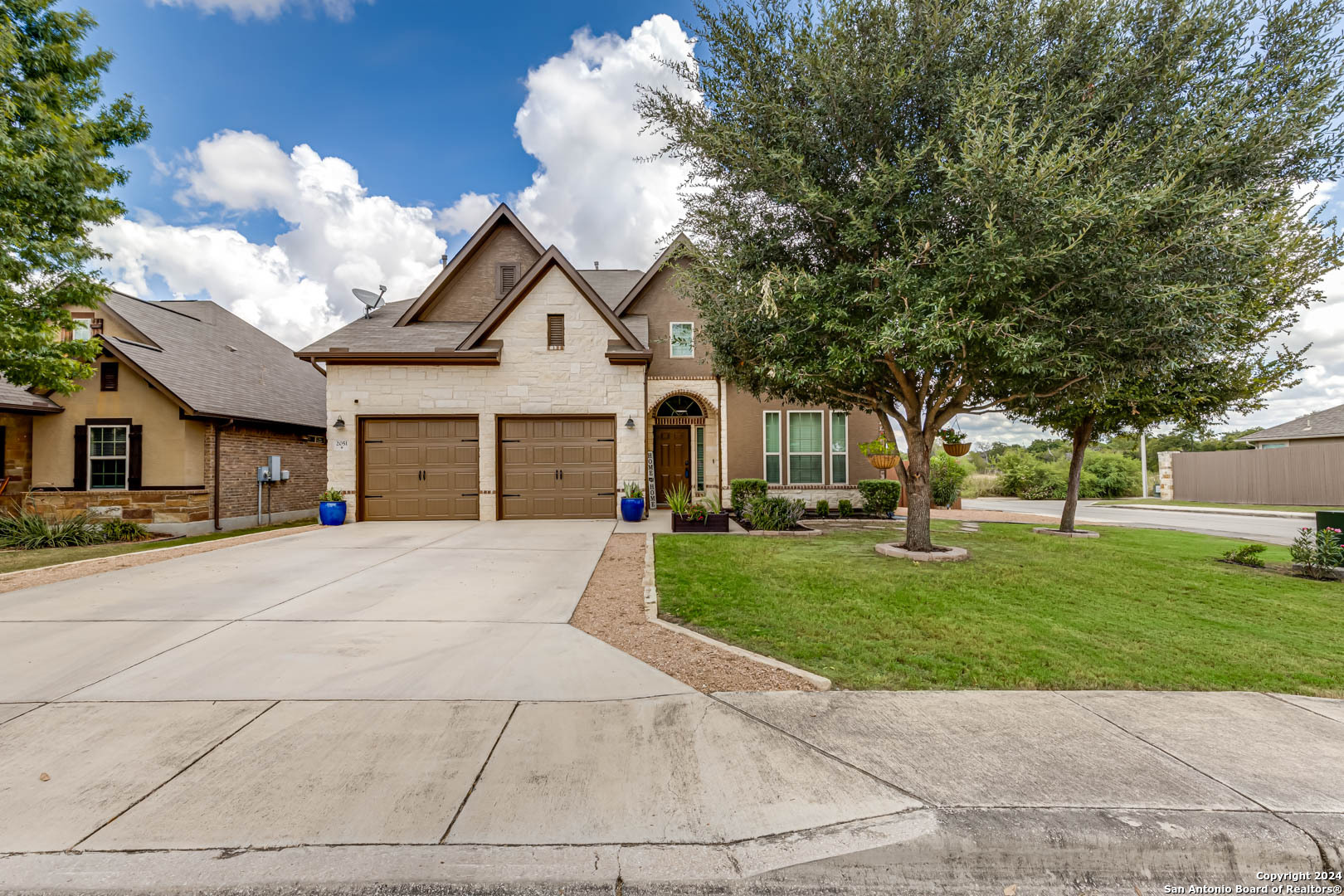 a front view of a house with a yard and garage