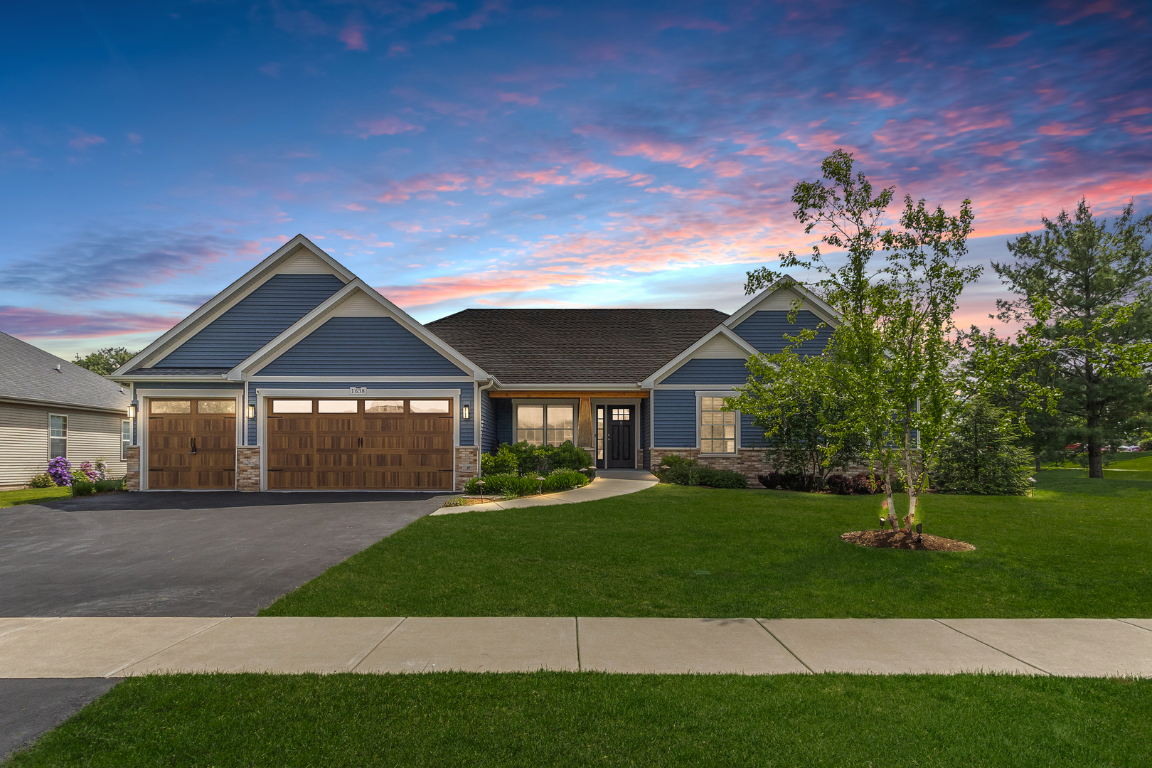 a front view of a house with a yard and garage