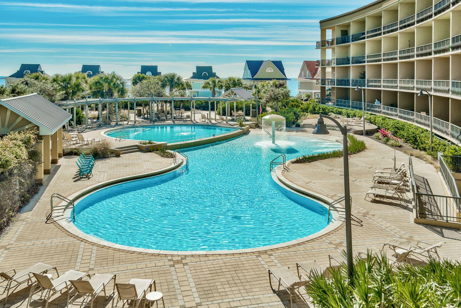 a view of a swimming pool with outdoor seating