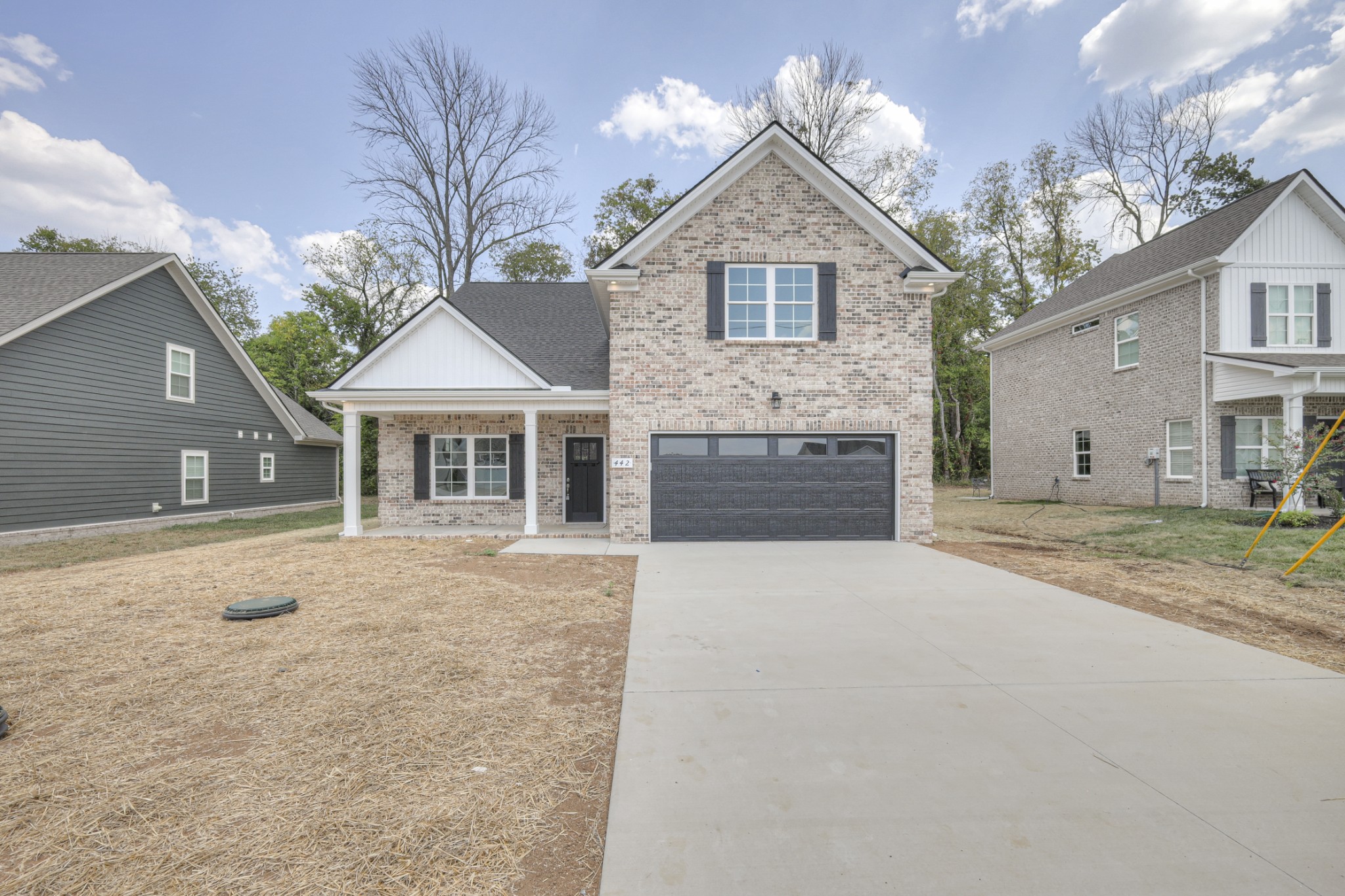 a front view of a house with a yard and garage