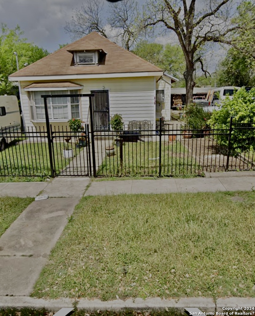 a front view of a house with a garden