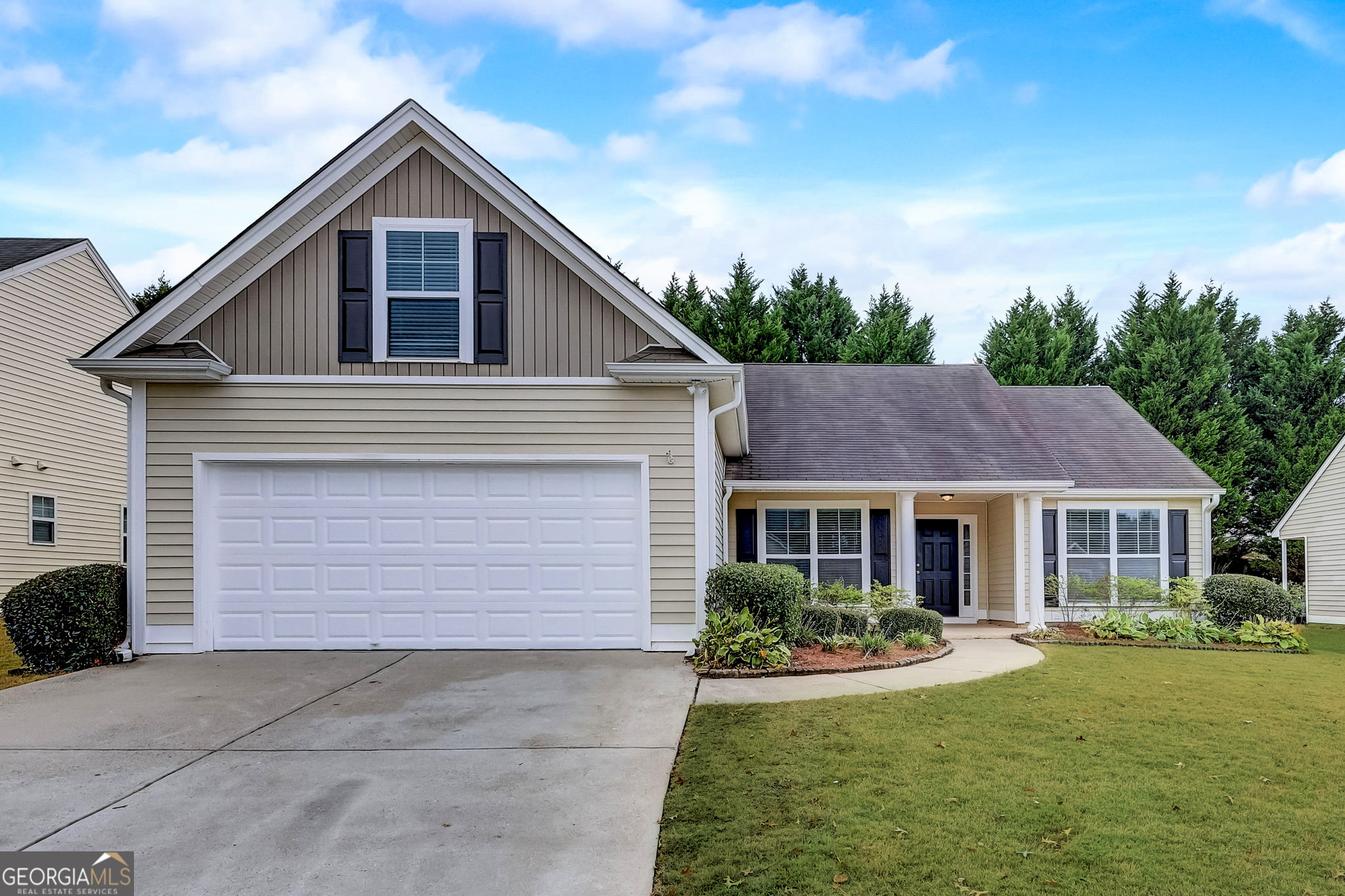 a front view of a house with a yard and garage