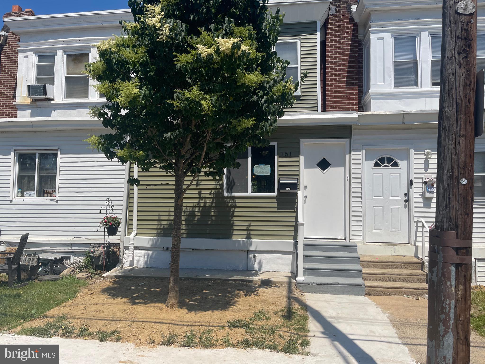 a front view of a house with plants