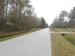 a view of a field with trees in the background