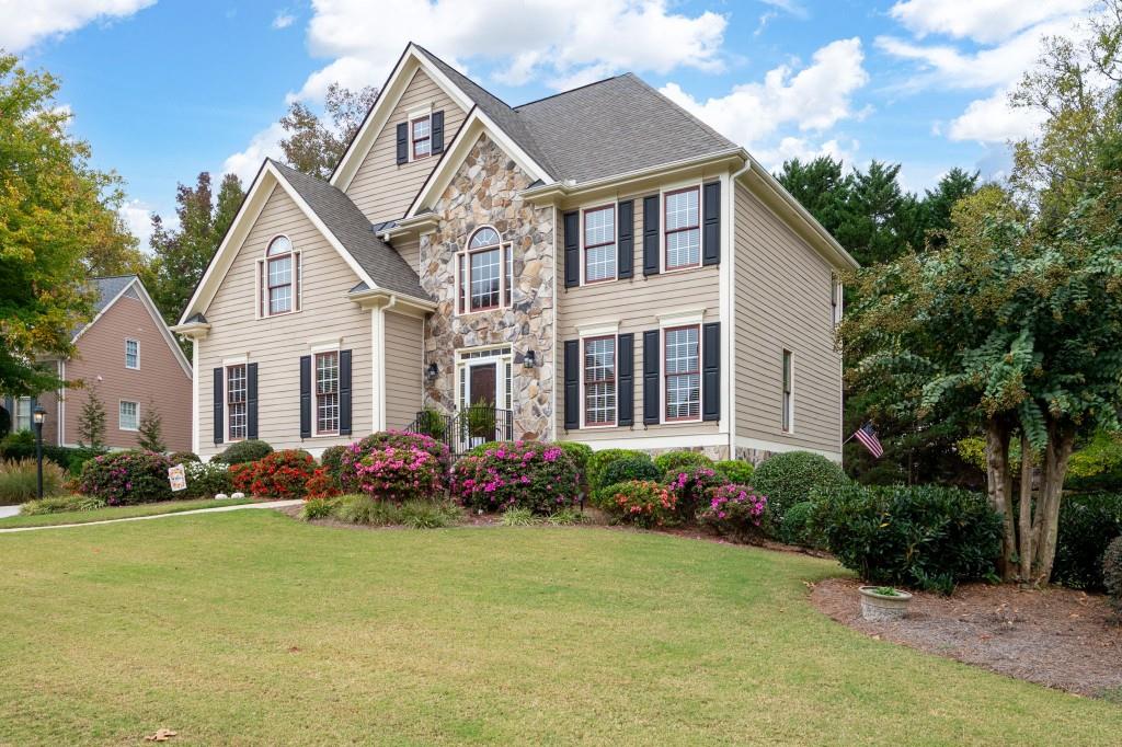 a front view of a house with garden