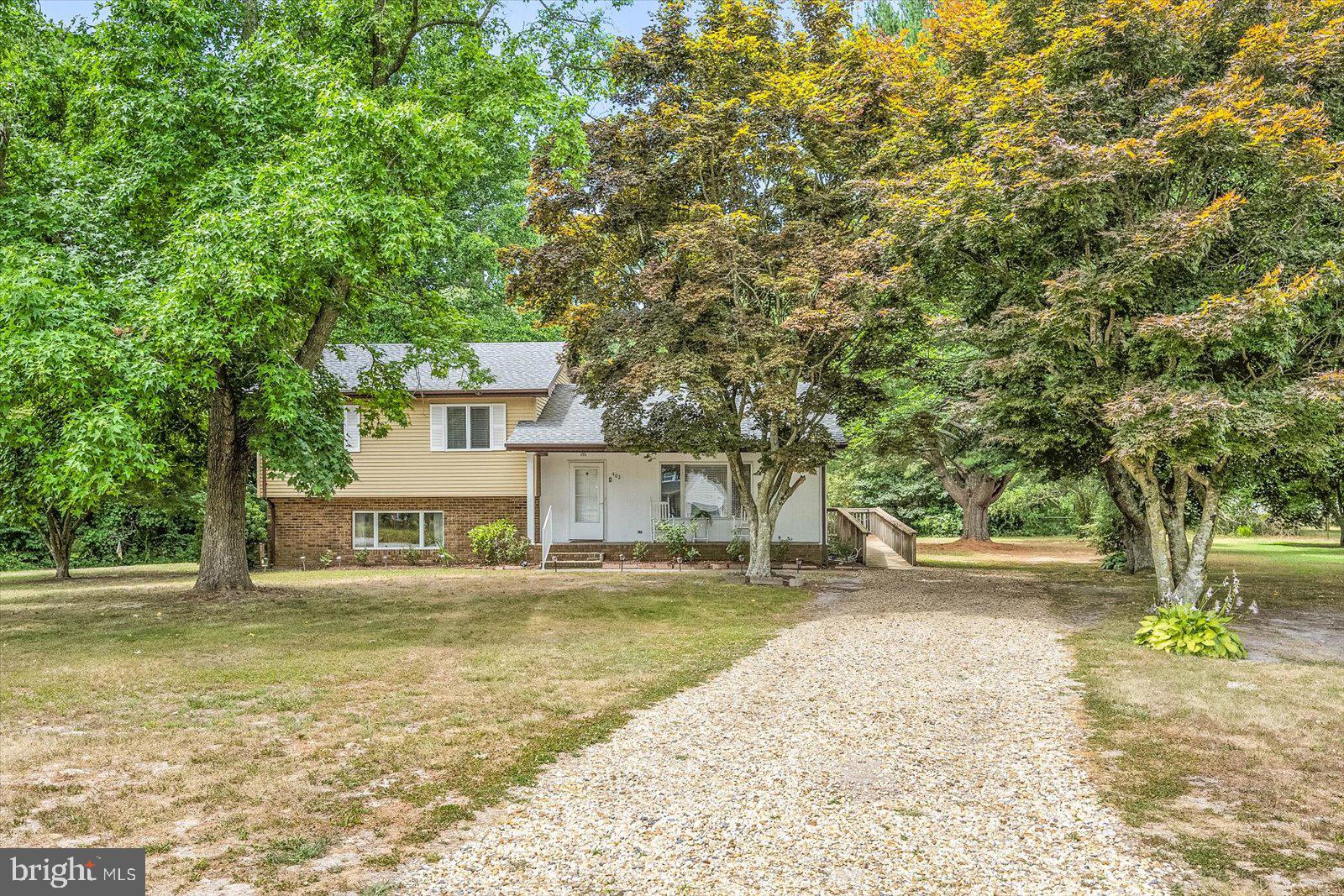 a view of a house with a yard and sitting area