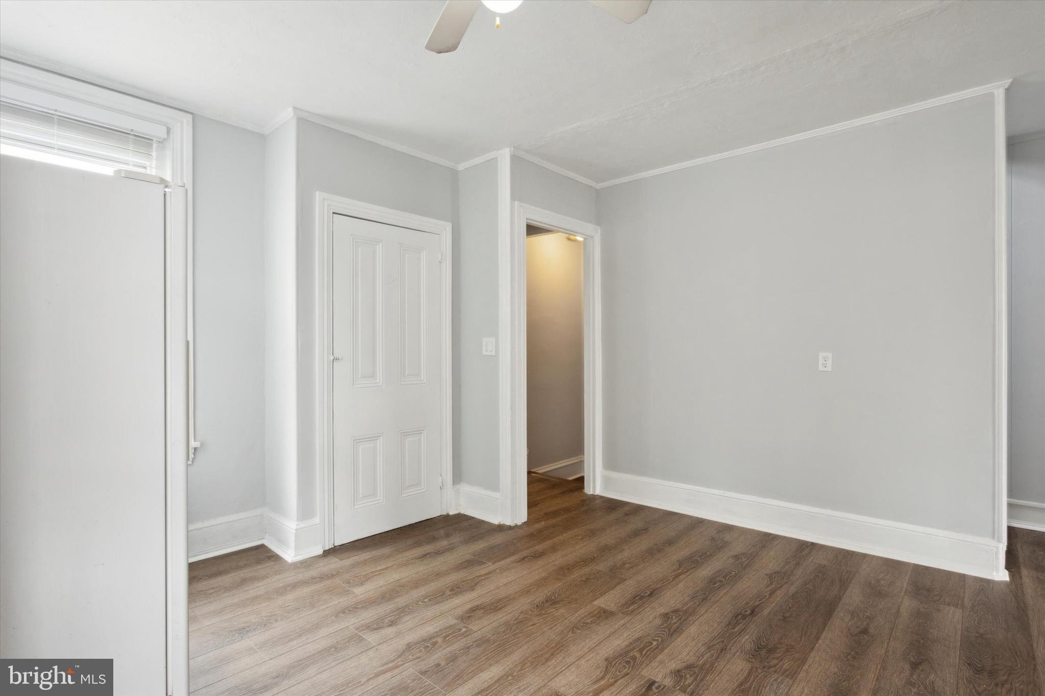 a view of an empty room with wooden floor