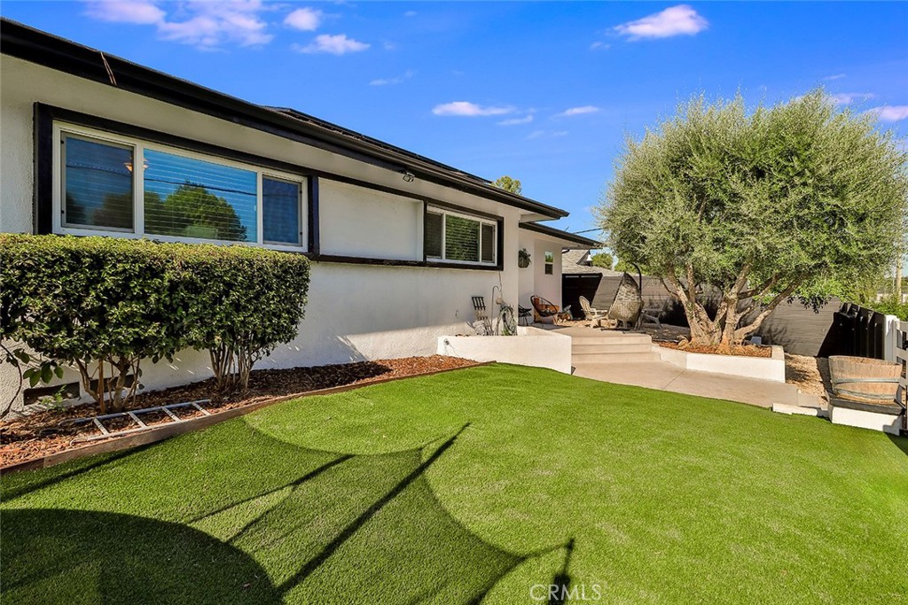 a house view with swimming pool and sitting space