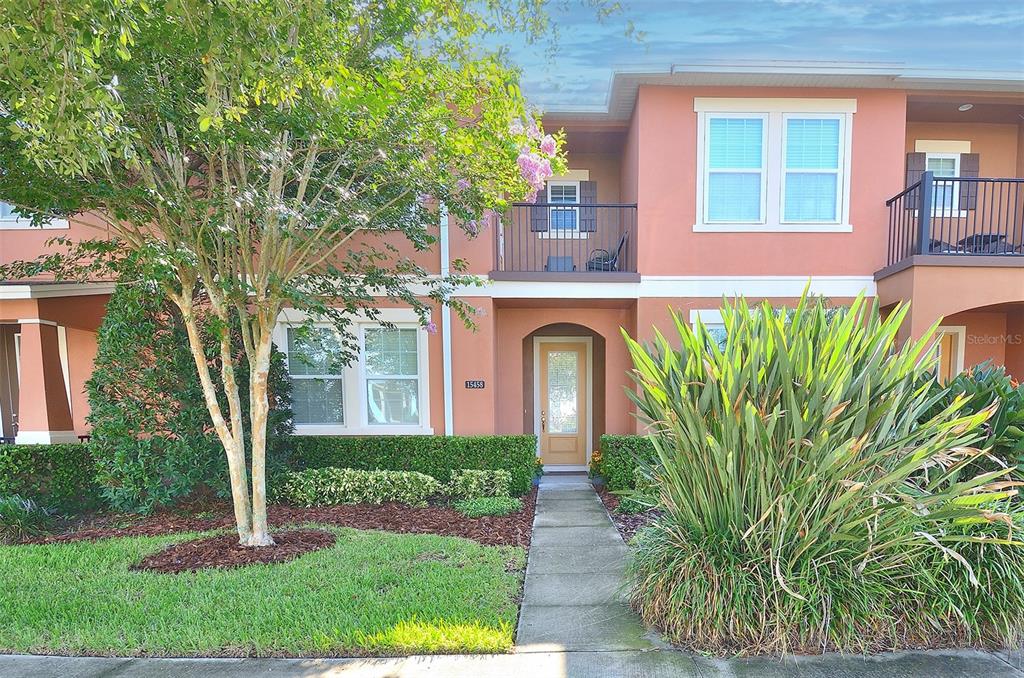 a front view of a house with garden