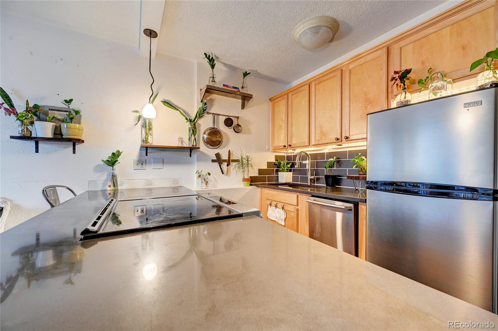 a kitchen with stainless steel appliances a refrigerator sink and white cabinets