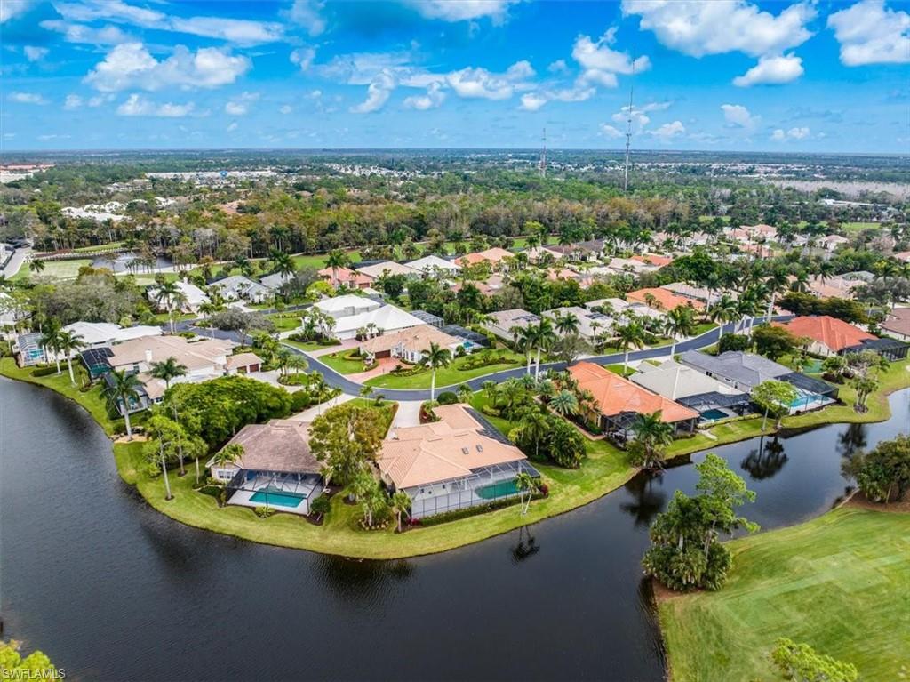 an aerial view of residential houses with outdoor space and street view