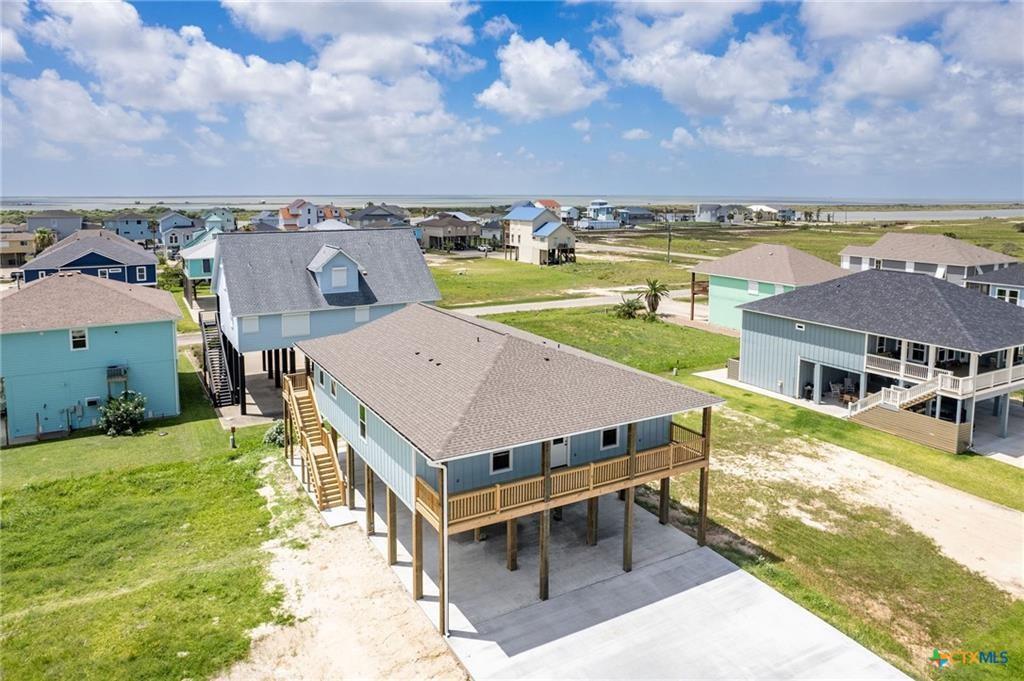 an aerial view of a house with big yard