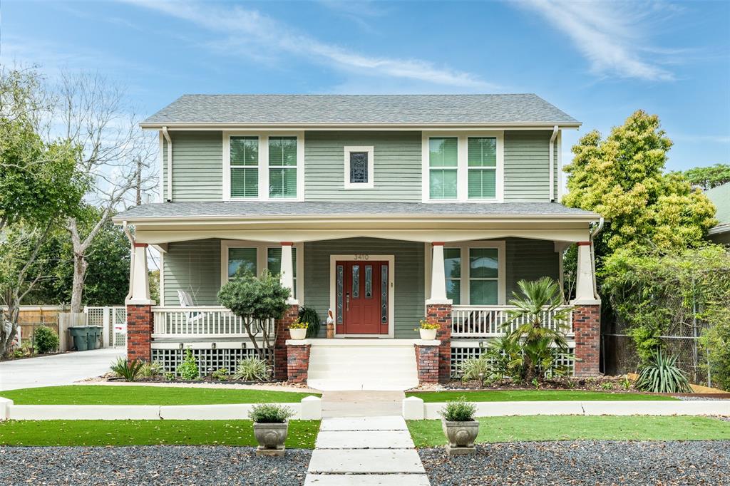 a front view of a house with a yard and potted plants