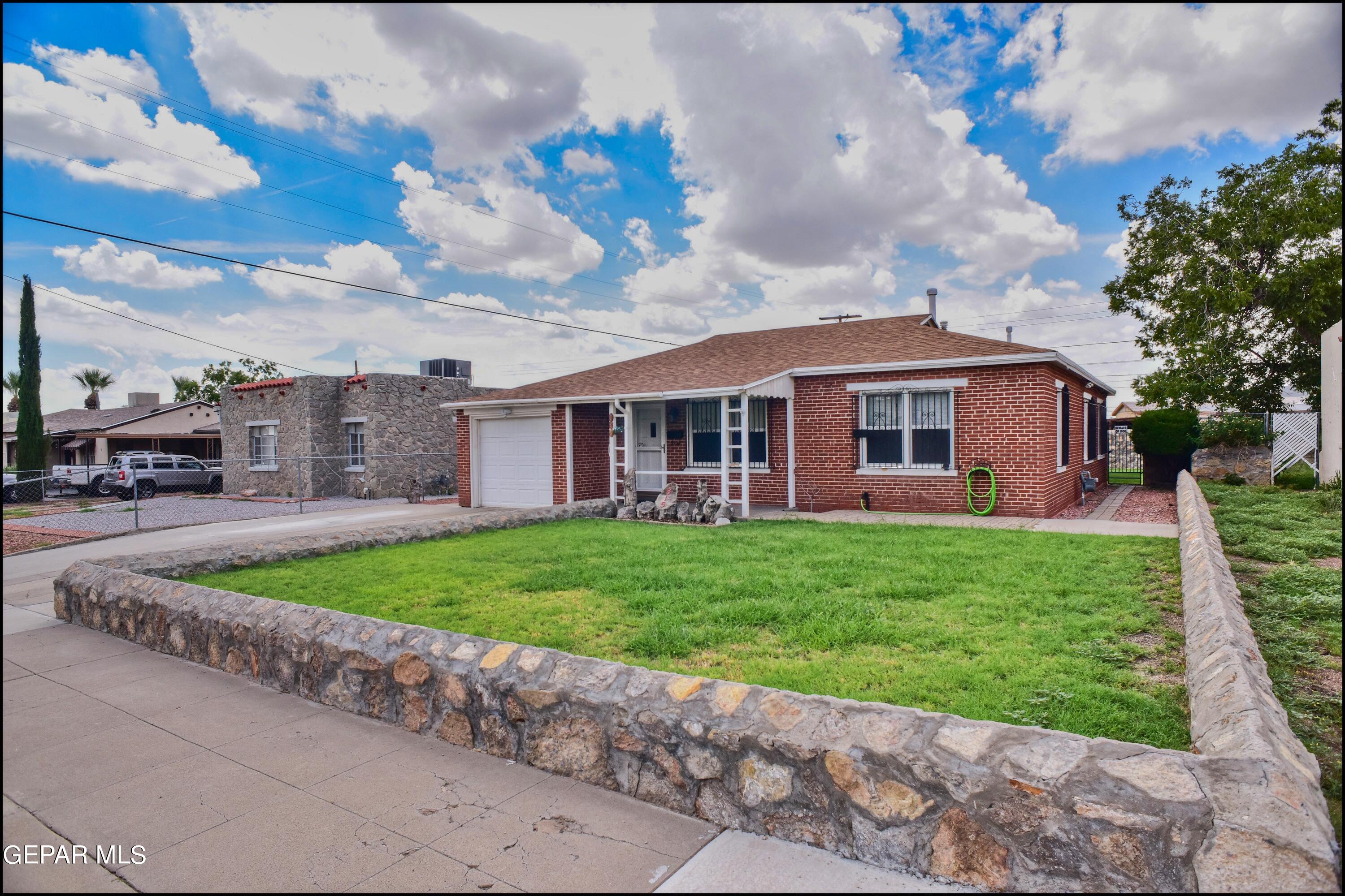 a view of a house with a yard