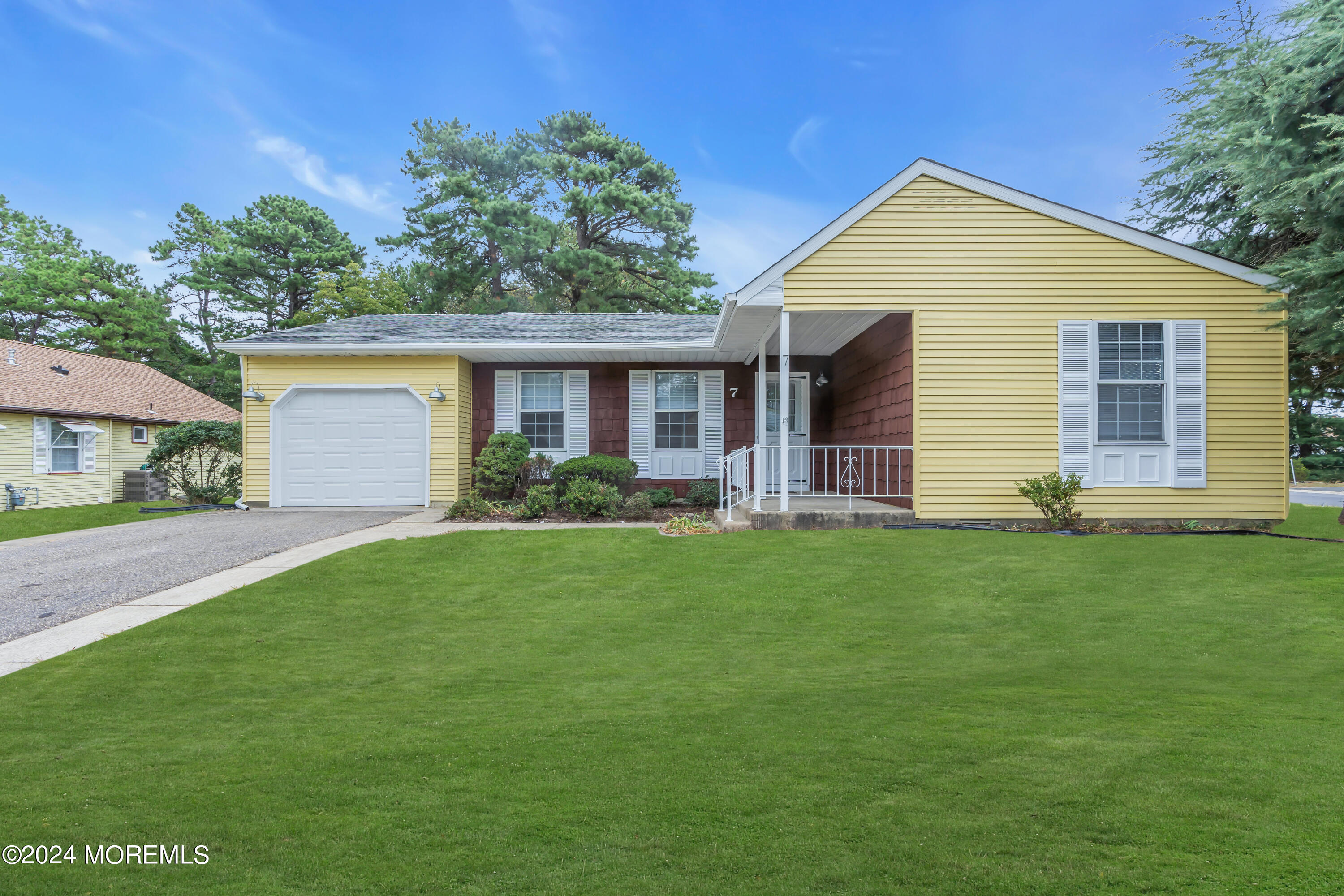 a front view of house with yard and green space