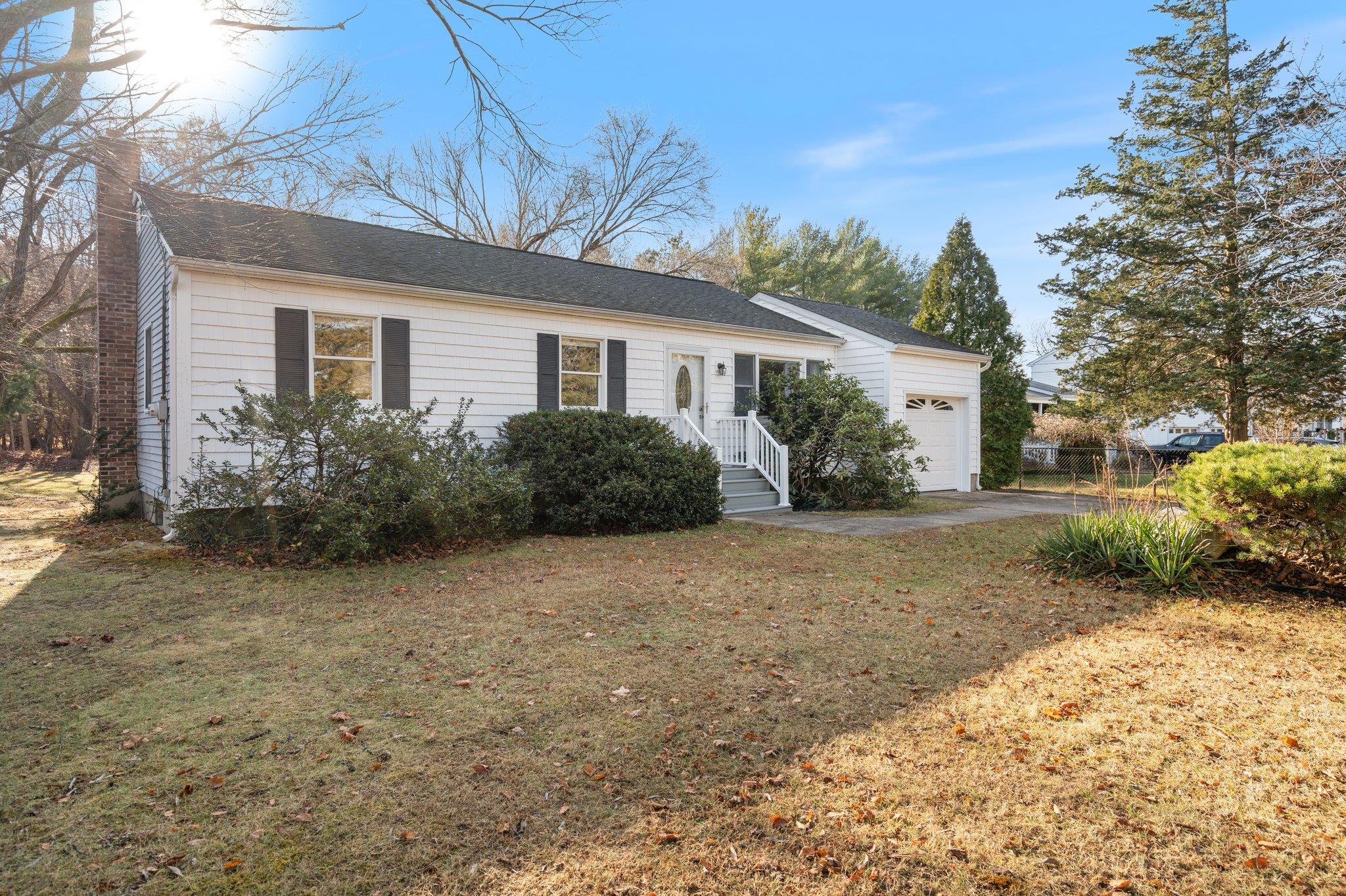 Ranch-style home with a front yard and a garage